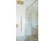 Bathroom shower featuring white tile, gold trim, a glass door, and a gold rain-style shower head at 244 Stilwell Oaks Cir, Charlotte, NC 28212