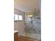 Modern bathroom featuring a glass-enclosed shower with decorative tile and gold hardware at 244 Stilwell Oaks Cir, Charlotte, NC 28212