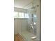 Bathroom shower featuring gray marble, gold trim, white tiles, a glass door, and a gold rain-style shower head at 244 Stilwell Oaks Cir, Charlotte, NC 28212