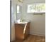 Bathroom vanity featuring light wood cabinets, white countertop, gold faucet, gold hardware, and a decorative mirror at 244 Stilwell Oaks Cir, Charlotte, NC 28212