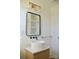 Modern bathroom featuring round sink, wood vanity, black framed mirror and gold fixtures at 244 Stilwell Oaks Cir, Charlotte, NC 28212