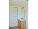 Bathroom vanity featuring light wood cabinets, white countertop, gold faucet, gold hardware, and attractive wall shelving at 244 Stilwell Oaks Cir, Charlotte, NC 28212