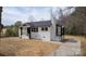 Charming home featuring a painted brick facade, black trim and a new roof at 244 Stilwell Oaks Cir, Charlotte, NC 28212