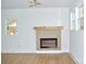 Modern fireplace with wooden mantle and light-colored surround at 244 Stilwell Oaks Cir, Charlotte, NC 28212
