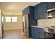 Updated kitchen with stainless steel refrigerator and blue cabinetry at 244 Stilwell Oaks Cir, Charlotte, NC 28212