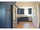 Stylish kitchen with stainless steel appliances and blue cabinets at 244 Stilwell Oaks Cir, Charlotte, NC 28212