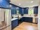 Bright kitchen featuring stainless steel appliances and stylish, modern navy cabinetry at 244 Stilwell Oaks Cir, Charlotte, NC 28212