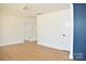 Open living room with white walls and neutral flooring at 244 Stilwell Oaks Cir, Charlotte, NC 28212