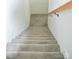 Carpeted stairway with light gray carpet and a light wood handrail at 244 Stilwell Oaks Cir, Charlotte, NC 28212