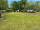 Expansive backyard featuring a lush green lawn and mature trees, perfect for outdoor activities and relaxation at 2458 Morningside Dr, Lancaster, SC 29720