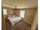 Cozy bedroom with carpet, two windows, and a ceiling fan at 2458 Morningside Dr, Lancaster, SC 29720