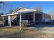 A charming single story home boasts a covered carport, mature trees, and a well-maintained lawn at 2458 Morningside Dr, Lancaster, SC 29720