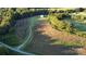 Gorgeous aerial view of sprawling farmland, with lush fields, mature trees, and a charming dwelling nestled amid nature at 3032 Morning Glory Ln, Vale, NC 28168
