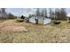 Large backyard with storage buildings and parking for trailers at 3032 Morning Glory Ln, Vale, NC 28168