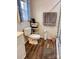 Bright bathroom featuring a toilet, storage shelf, and wood-look flooring at 3032 Morning Glory Ln, Vale, NC 28168