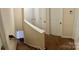 Upper hallway leads to carpeted stairs down, with closet doors and neutral wall paint at 3032 Morning Glory Ln, Vale, NC 28168