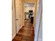 Hallway view into kitchen with white cabinets, stainless appliances, and center island at 3032 Morning Glory Ln, Vale, NC 28168
