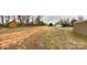 Wide-angle view of the yard, with storage buildings, offering ample space for outdoor activities and storage at 3032 Morning Glory Ln, Vale, NC 28168