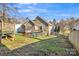 Fenced backyard with a deck, some play equipment, and a grassy lawn at 306 Chinaberry Dr, China Grove, NC 28023