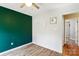 Bright bedroom with green accent wall and hardwood floors at 306 Chinaberry Dr, China Grove, NC 28023