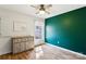 Bedroom with natural light, hardwood floors, and green accent wall at 306 Chinaberry Dr, China Grove, NC 28023