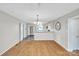 Inviting dining area adjacent to kitchen, featuring hardwood floors and neutral decor at 306 Chinaberry Dr, China Grove, NC 28023