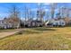 A well-landscaped front yard frames a cozy home with nearby houses under a bright sky at 306 Chinaberry Dr, China Grove, NC 28023