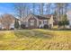 Charming home featuring a brick facade, green shutters, and a well-maintained lawn at 306 Chinaberry Dr, China Grove, NC 28023