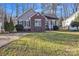 Charming home featuring brick accents, green shutters, and a well-maintained front lawn at 306 Chinaberry Dr, China Grove, NC 28023