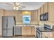 Well-lit kitchen features stainless steel appliances, a window over the sink, and marbled flooring at 306 Chinaberry Dr, China Grove, NC 28023