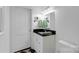 Bright, updated bathroom with a black granite countertop and modern fixtures at 4010 Hiddenbrook Dr, Charlotte, NC 28205