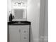 Neutral bathroom featuring a sleek vanity, modern fixtures, and a framed mirror at 4010 Hiddenbrook Dr, Charlotte, NC 28205