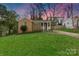 A charming single-story home with stone and brick accents, a front porch, and green lawn at 4010 Hiddenbrook Dr, Charlotte, NC 28205