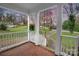 Inviting front porch features white railings, brick floor, and hanging flower baskets at 4010 Hiddenbrook Dr, Charlotte, NC 28205
