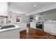 Open concept kitchen with hardwood floors and stainless steel appliances at 4010 Hiddenbrook Dr, Charlotte, NC 28205