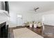 Bright living room with fireplace, hardwood floors, and white wainscoting at 4010 Hiddenbrook Dr, Charlotte, NC 28205
