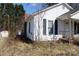 Quaint home featuring white siding, black shutters and a classic brick chimney at 438 Pop Davis Rd, Taylorsville, NC 28681