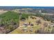 Expansive aerial view highlighting a rural property with lush forests and diverse residential areas at 4783 Rainey Ln, Maiden, NC 28650