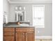Bathroom with a granite countertop, hardwood vanity, and framed mirror at 4783 Rainey Ln, Maiden, NC 28650