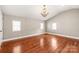 Bright bedroom with hardwood floors, chandelier lighting, and ample natural light from multiple windows at 4783 Rainey Ln, Maiden, NC 28650