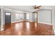 Spacious living room with hardwood flooring, large windows, and a neutral color palette at 4783 Rainey Ln, Maiden, NC 28650