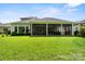 The lovely backyard of this home features a screened in porch and ample green space at 4922 Looking Glass Trl, Denver, NC 28037