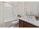 Clean and modern bathroom with a white vanity, shower-tub combo, and stylish fixtures at 4922 Looking Glass Trl, Denver, NC 28037
