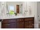 Bathroom with white countertops, double vanity, wood cabinets, and modern fixtures at 4922 Looking Glass Trl, Denver, NC 28037