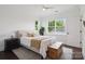 Bright bedroom with hardwood floors, white walls, large windows, a wood chest and ceiling fan at 4922 Looking Glass Trl, Denver, NC 28037