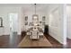 Dining area featuring a formal dining table, modern light fixture, and built-in cabinets for dinnerware and glassware at 4922 Looking Glass Trl, Denver, NC 28037