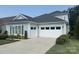 Home with a two-car garage and well-manicured landscaping, driveway, and charming architectural details at 4922 Looking Glass Trl, Denver, NC 28037