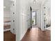 Bright hallway with elegant wainscoting, hardwood floors, and a view of the front door at 4922 Looking Glass Trl, Denver, NC 28037