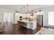 Bright and open kitchen with a large island, stainless steel appliances, and hardwood floors at 4922 Looking Glass Trl, Denver, NC 28037