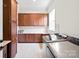 Well-equipped laundry room with modern washer and dryer, wood cabinets, and ample counter space at 4922 Looking Glass Trl, Denver, NC 28037